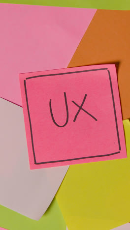 Vertical-Video-Business-Concept-Of-Revolving-Sticky-Notes-With-Acronym-UX-Written-On-Top-Note